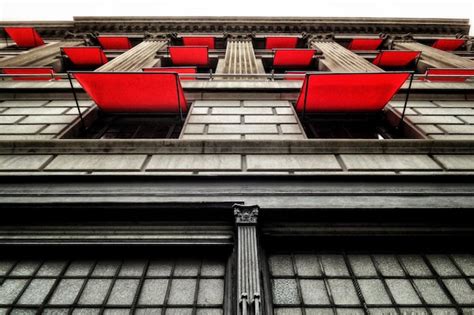 Premium Photo Low Angle View Of Building With Red Awnings On Window