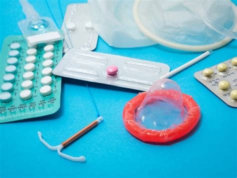 An Assortment Of Medical Supplies On A Blue Surface With One Pill