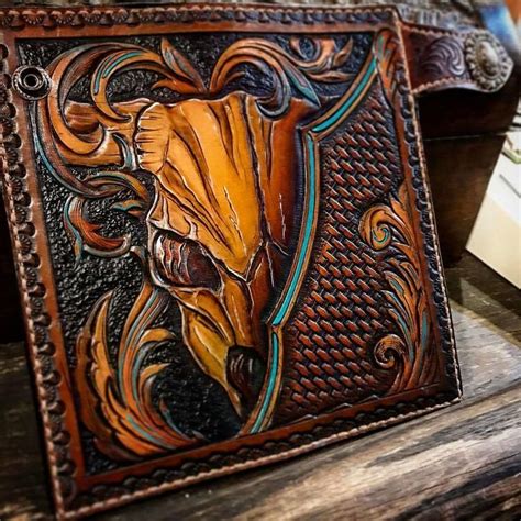 an intricately decorated wallet sitting on top of a wooden table