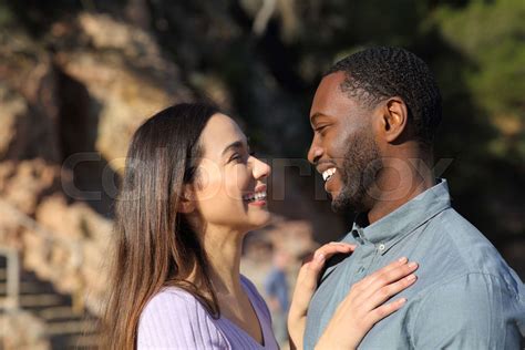 Happy Interracial Couple Flirting In Love Looking Each Other Stock