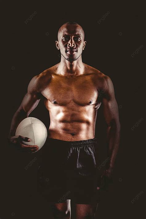 Portrait Of Shirtless Sportsman Holding Rugby Ball Confident Sport