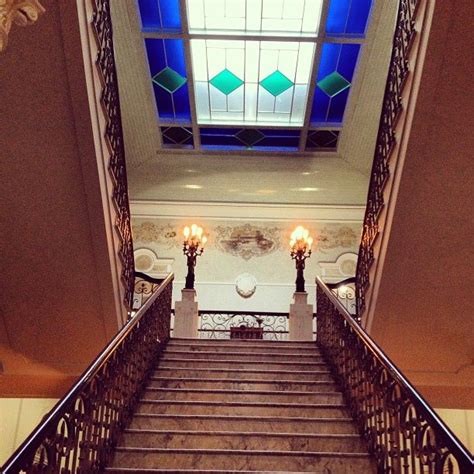 The Stairs Are Made Of Marble And Leaders With Stained Glass Above Them