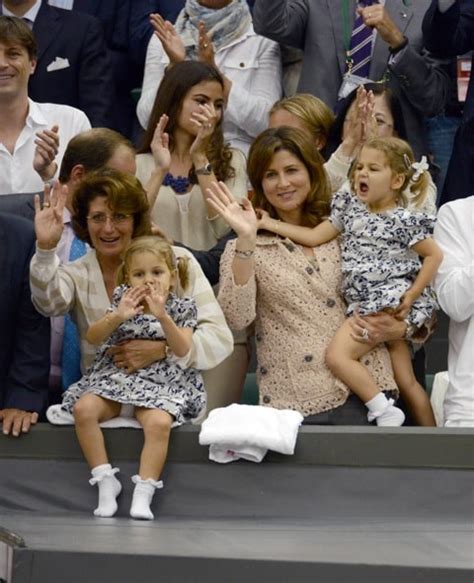 Mirka Federer watches husband Roger Federer with her twin daughters ...