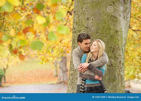 Romantic Teenage Couple By Tree In Autumn Park Stock Photo Image Of