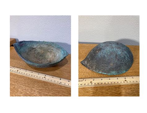 Quite heavy, and appears to be copper, brass, or bronze,very crudely