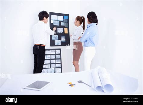 three interior designers working on a portfolio Stock Photo - Alamy