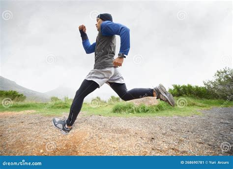 Training in the Great Outdoors. a Young Man Running in Rugged Outdoor ...