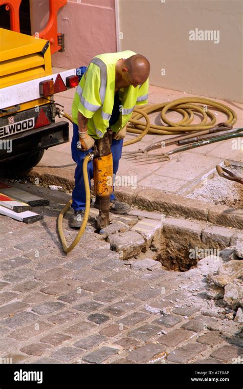 roadworks workman   pneumatic drill  dig  hole   road
