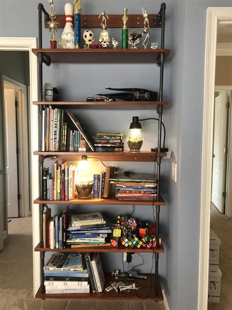 Homemade Shelves Made With Poplar Wood And Plumbing Pipes From Home