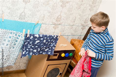 laundry service. kid doing laundry with homemade corrugated cardboard ...