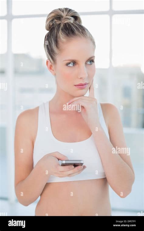 Thoughtful Sporty Blonde Text Messaging Stock Photo Alamy