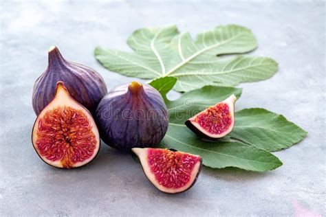 Close Up Of Whole And Sliced Figs On Big Fig Leaves Fresh Ripe Fruits