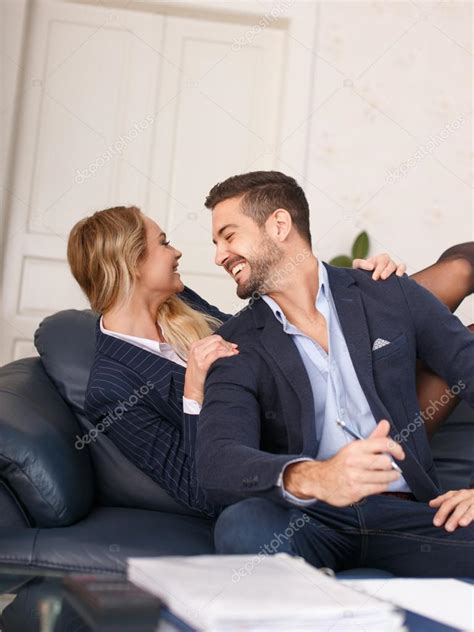 Blonde Businesswoman Fall Behind Boss Onto Sofa Stock Photo Image By Sakkmesterke