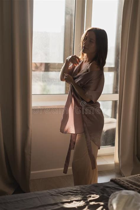 Young Woman Enjoying Sunny Morning On Bedroom Wake Up And Wellness