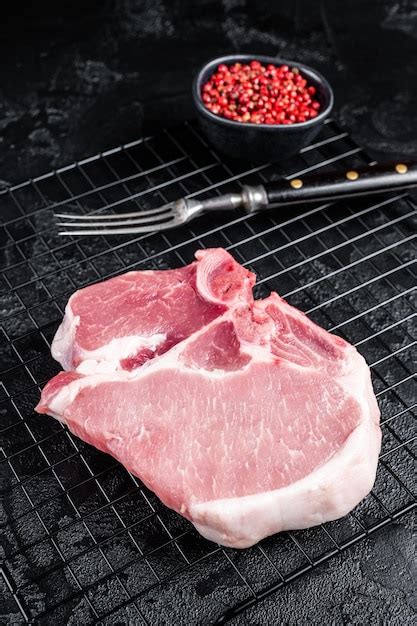 Premium Photo Uncooked Raw Pork T Bone Chop Meat Steak On Grill Black