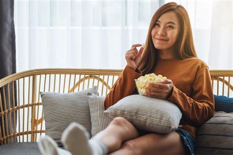 Premium Photo Closeup Image Of A Young Woman Holding And Eating Pop