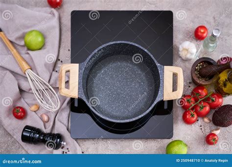 Boiling Water In A Cooking Pot An A Pan On A Induction Stove At