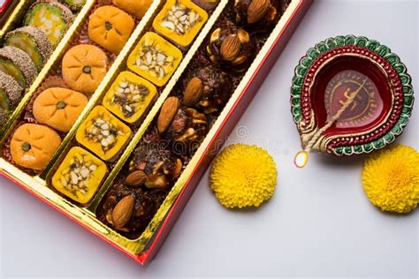 Indian Sweets Or Mithai For Diwali Festival With Oil Lamp Or Diya And