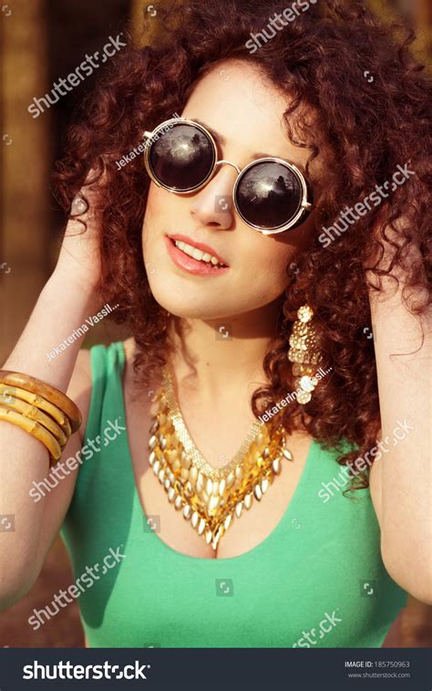 Portrait Of Albanian Female Wearing Sunglasses And Touch Her Natural