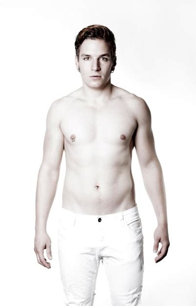 Premium Photo Portrait Of Shirtless Man Standing Against White Background