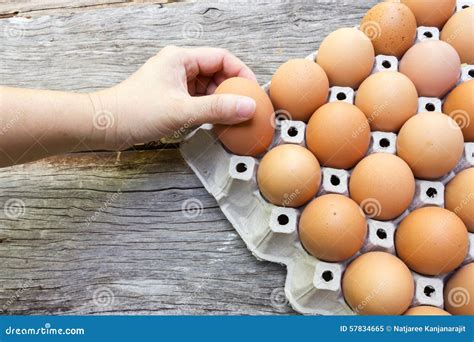 Woman S Hand Picking Egg From Egg Tray Stock Image Image Of Wooden