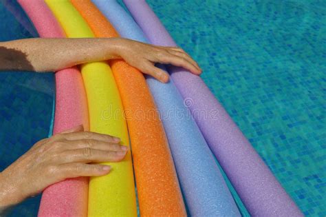 Hands On Rainbow Pool Noodles In Swimming Pool Stock Image Image Of