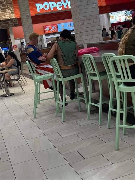 Several People Sitting At Tables In A Restaurant With Chairs Around