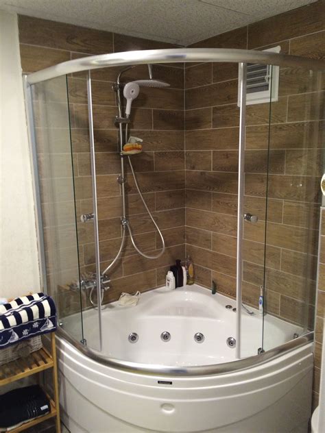 Corner Bathtub And Shower In A Spacious Bathroom