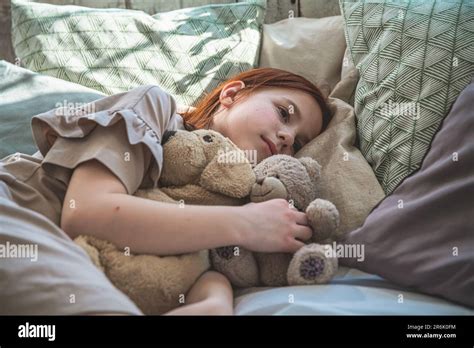 Beautiful Cute Little Girl Sleeping Peacefully And Hugging Her Stuffed