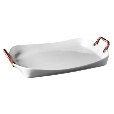 An Oval White Dish With Copper Handles