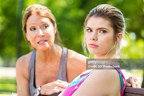 Upset Teenage Daughter Ignoring Her Concerned Mother During An Argument