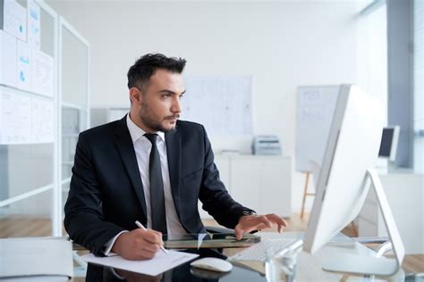 Free Photo | Busy Caucasian man in suit sitting in office and working ...