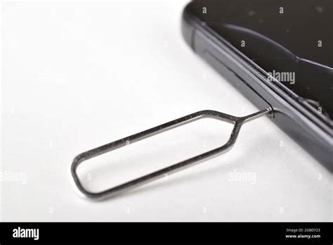 Sim Ejector Tool Inserted In Smartphone Stock Photo - Alamy