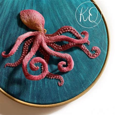 An Embroideryed Octopus On A Blue Background With The Letter K3 In It S