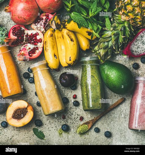 Colorful smoothies in bottles with fresh tropical fruit, square crop Stock Photo - Alamy