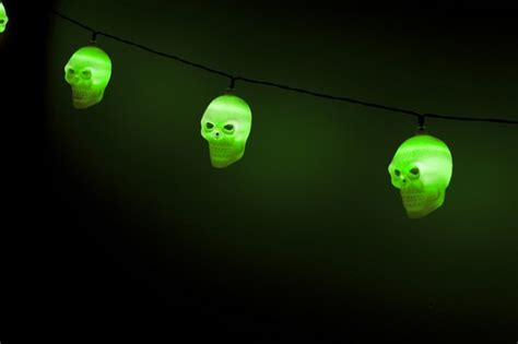 Image of Glowing string of ghoulish green skull lights ...