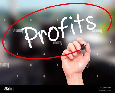 man hand writing profits  black marker  visual screen stock photo