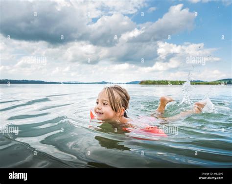 Girl swimming in lake Stock Photo - Alamy