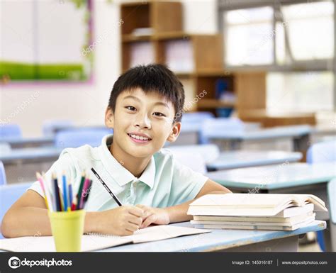 Asian Schoolboy Studying In Classroom — Stock Photo © Imtmphoto 145016187