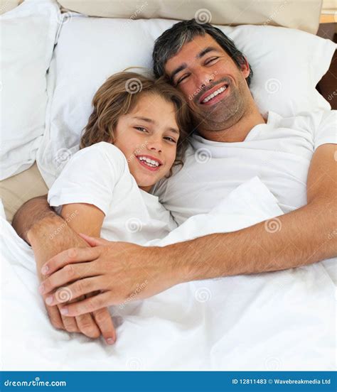 Loving Father Hugging His Son Lying On The Bed Stock Image Image Of Male Relationship 12811483