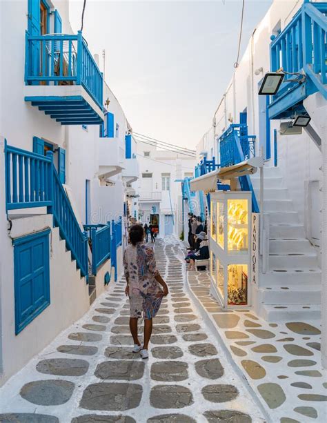 Tourist At The Streets Of Mykonos Greek Village In Greece Colorful