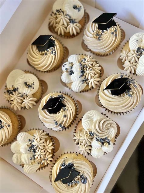 Cupcakes With White Frosting And Black Icing Decorated With Graduation