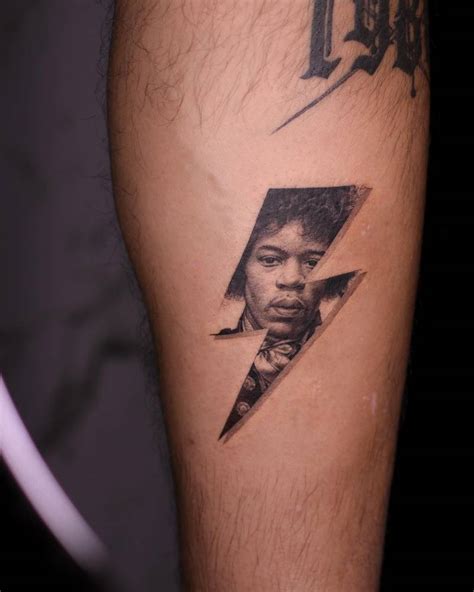 Lightning bolt Jimi Hendrix tattoo located on the calf.