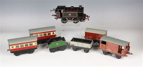 A Hornby Gauge O Clockwork 0 4 0 Tank Locomotive Two Coaches A Tender