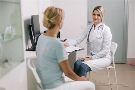 Doctor Consulting Young Woman In Hospital Stock Photo Image Of