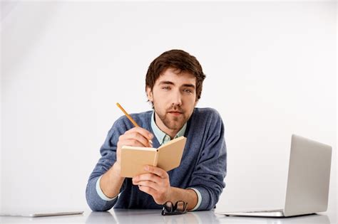 Free Photo Young Smart And Thoughtful Handsome Guy Writing Down