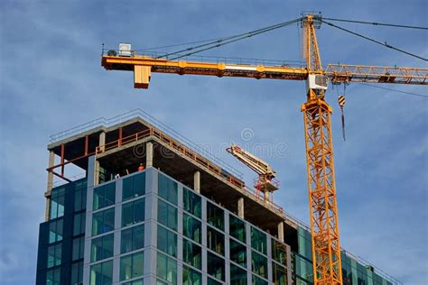 Cranes Rising Above A Building Under Construction Stock Image Image