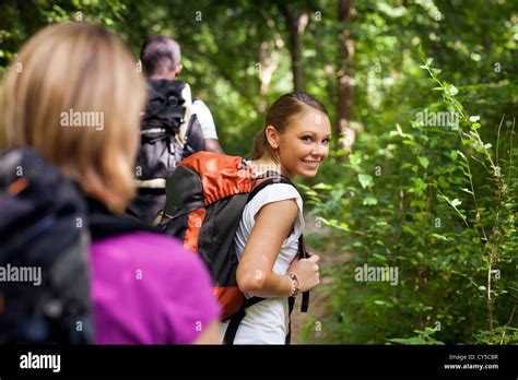 group of man and women during hiking excursion in woods, with woman ...