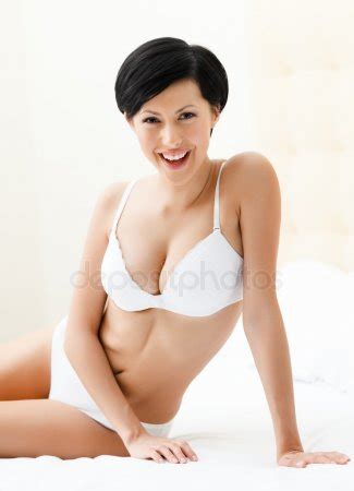 Woman In White Underwear Is Lying In The Comfortable Bed Stock Photo