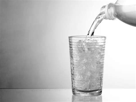 Premium Photo Water Being Poured In Glass Against White Background